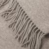 Close-up of beige wool throw with fringe