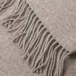 Close-up of beige wool throw with fringe