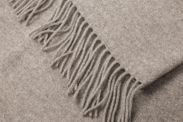 Close-up of beige wool throw with fringe