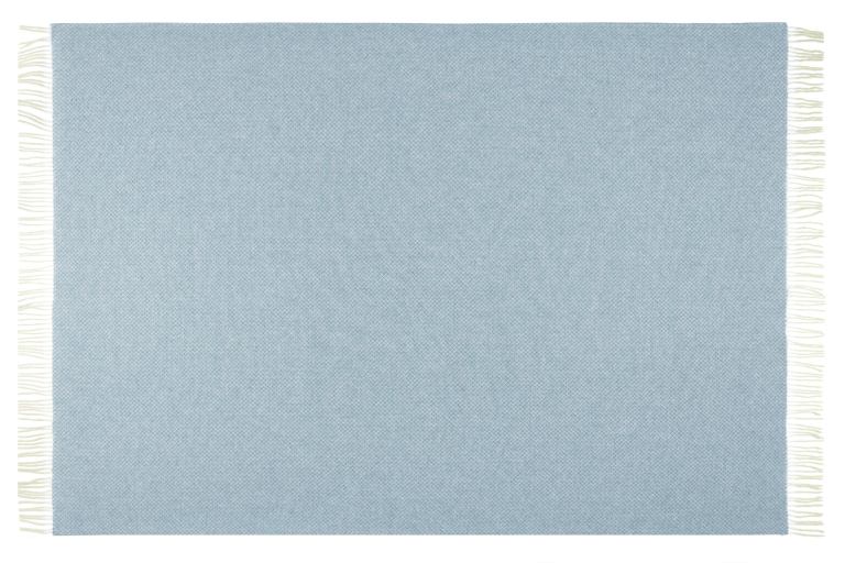 Light blue woven rug with fringe edges