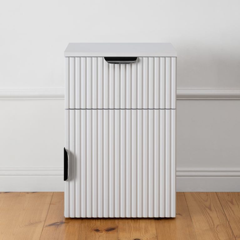 White fluted cabinet on wooden floor