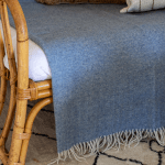 Blue herringbone throw on rattan daybed