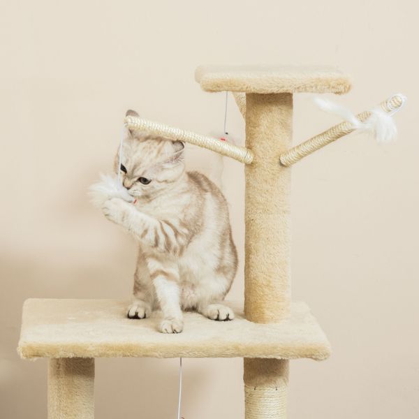 Kitten playing with feather toy on cat tree
