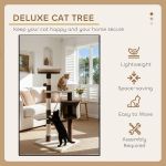 Two cats playing on deluxe cat tree indoors