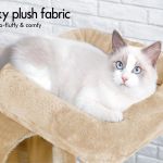 Fluffy cat resting on plush cat tree bed