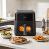 Modern air fryer cooking chips on kitchen counter