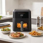 1400w 5l non stick digital air fryer with clear viewing window Modern air fryer cooking chips on kitchen counter