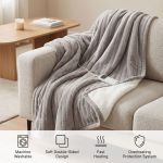 Grey electric heated throw on sofa