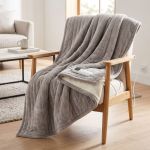 Electric heated blanket on armchair with remote control