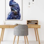 Framed blue cockatoo artwork above modern wooden desk
