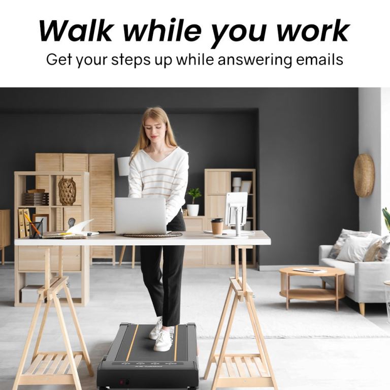 Woman working on laptop at treadmill desk