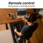 Man using remote on under-desk treadmill