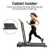 Woman jogging on treadmill with tablet holder