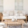 Coastal style sofa with neutral cushions and timber table