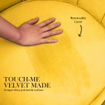 Hand touching yellow velvet chair cushion
