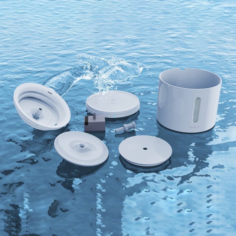 Disassembled white pet water fountain in water