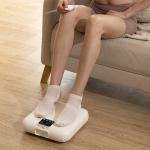 Person using electronic foot massager at home