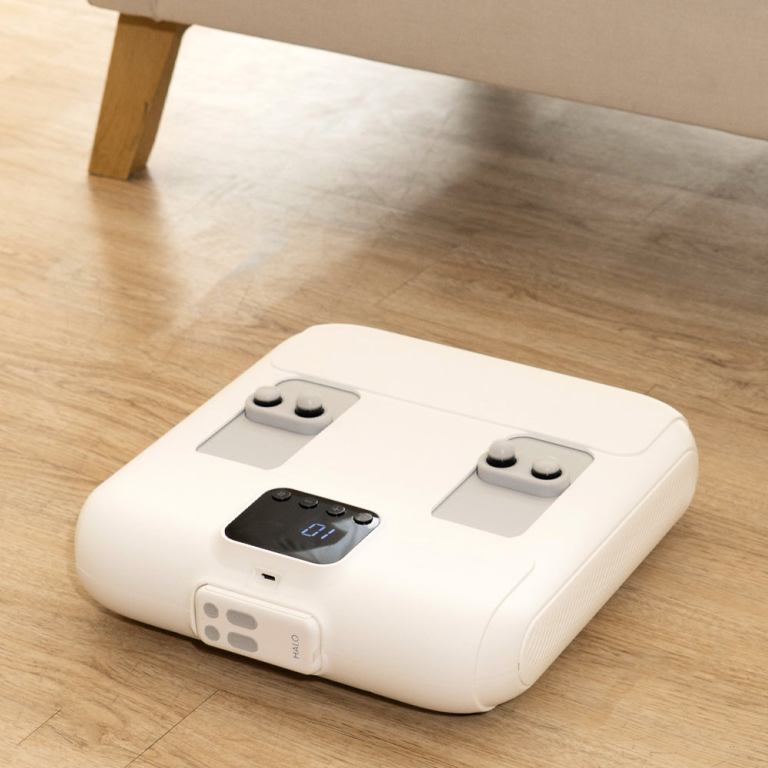 White digital bathroom scale on wooden floor