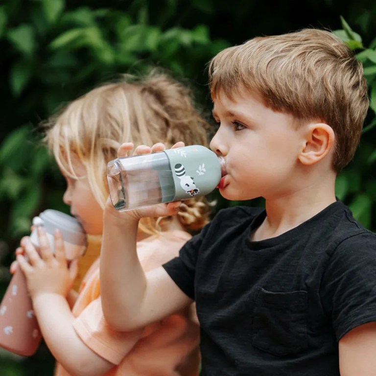 monbento mb positive s reusable water bottle raccoon Two children drinking from reusable water bottles outdoors