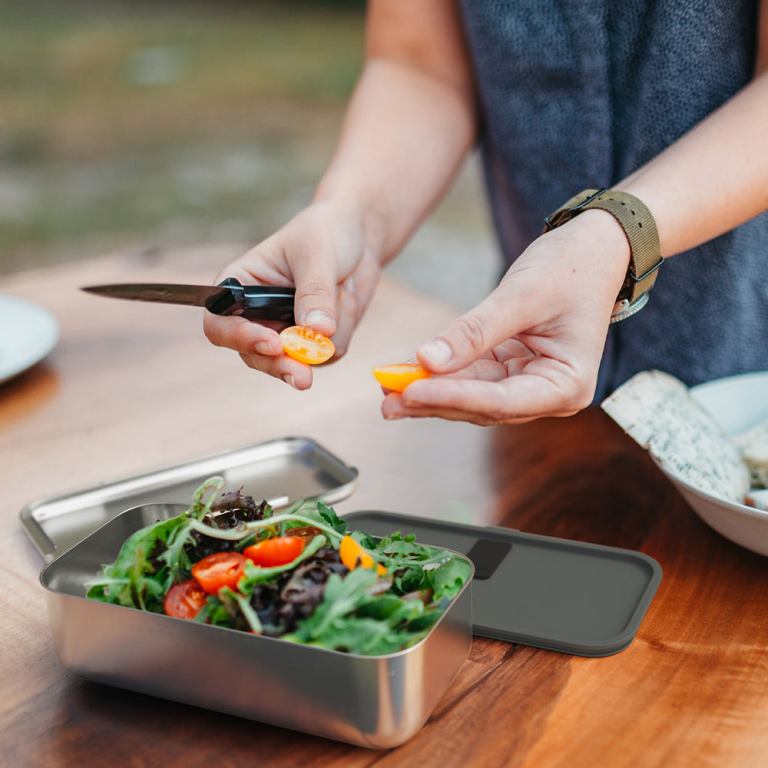 monbento mb sense bento box canyon Person slicing cherry tomatoes over fresh salad