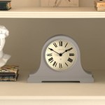 Grey mantel clock with Roman numerals on shelf
