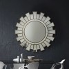 Sunburst mirror above modern dining table