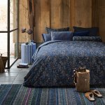 Rustic bedroom with floral bedding and timber walls