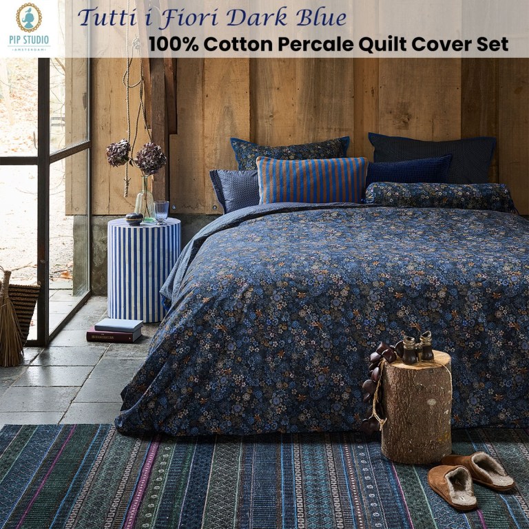 Dark blue floral quilt cover set on bed