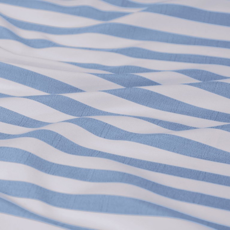 Blue and white striped fabric with soft folds