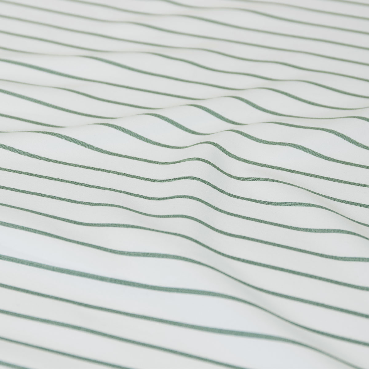 Close-up of white fabric with green stripes
