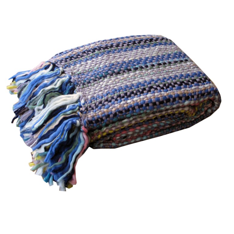 Folded blue woven throw blanket with tassels