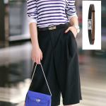 Black leather belt with silver buckle on outfit