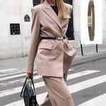 Woman in beige suit with black belt
