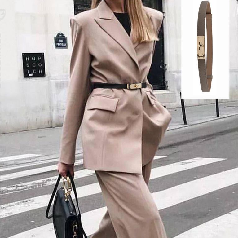 Woman in beige suit with black belt