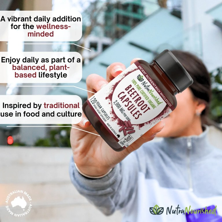 Hand holding beetroot capsules supplement bottle outdoors