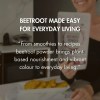 Person holding beetroot powder pouch in kitchen