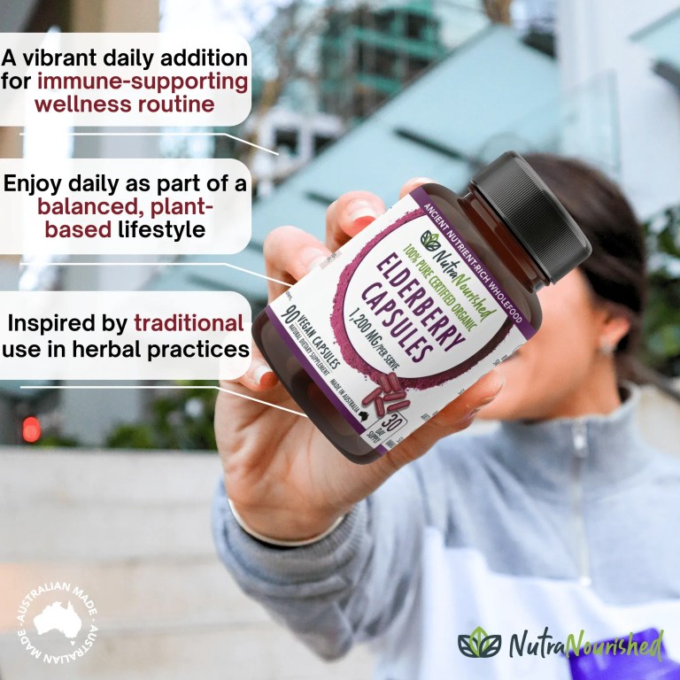 Hand holding NutraNourished elderberry capsules bottle outdoors