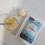 Electrolyte turmeric drink with ice and powder scoop