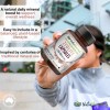 Hand holding Australian zeolite supplement capsules bottle