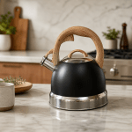 Black kettle with wooden handle on marble bench