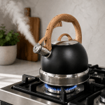 Black kettle steaming on gas stove