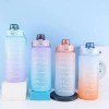 Four pastel gradient water bottles with flip lids