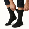 v563 cottonltsox blk11 14 202603161820 00.png Person pulling up black socks on white background
