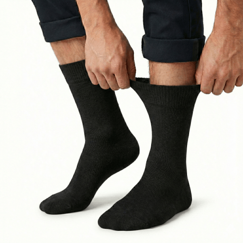 v563 cottonltsox blk11 14 202603161820 00.png Person pulling up black socks on white background