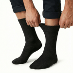 1x pair cotton rich loose top socks circulation diabetic comfort in black 11 14 Person adjusting black crew socks