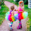 Two children in rainbow tutus holding hands