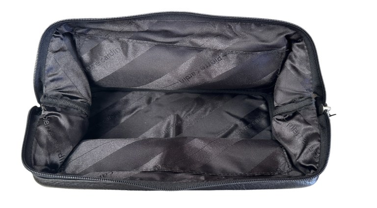 Open black toiletry bag with padded interior