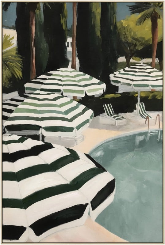 Striped umbrellas beside sunlit swimming pool