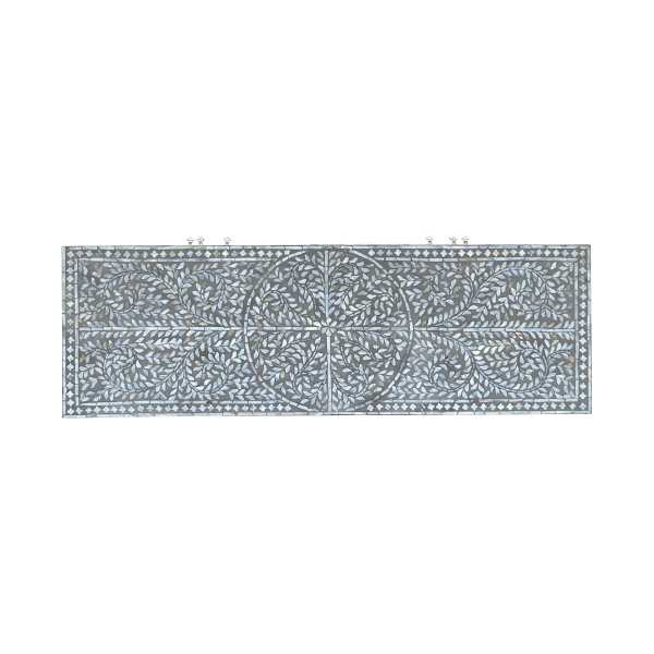 Intricate floral inlay panel on dark wood