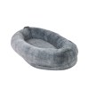 Grey plush oval pet bed on white background